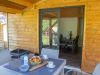 Breakfast on the wooden terrace of a Libella family chalet at Détente et Clapotis campsite, Lake Paladru